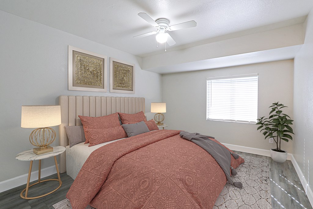 a bedroom with a bed and a ceiling fan
