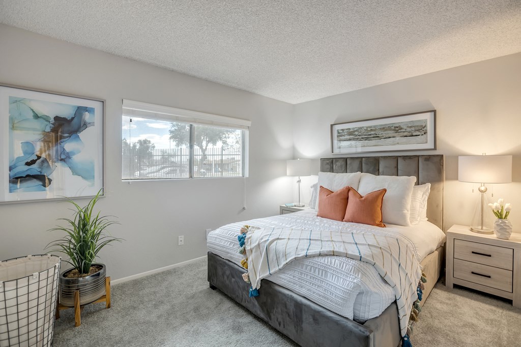 a bedroom with a bed and two windows