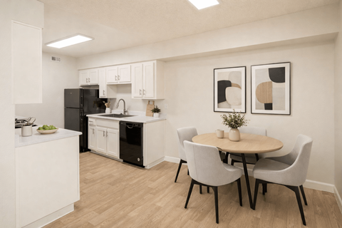 A kitchen with a table and chairs.