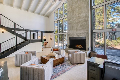 a living room with couches and chairs and a fireplace