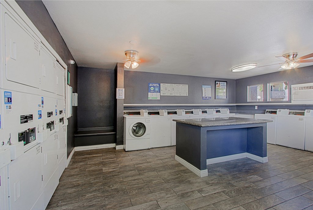 a laundry room with washer and dryer and a counter with a washing machine