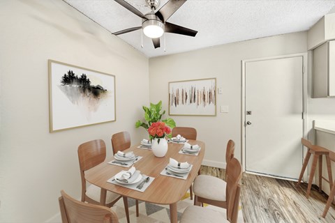 A dining room with a table set for six and two chairs.