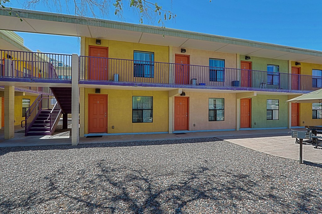 A building with yellow, orange, and green doors.