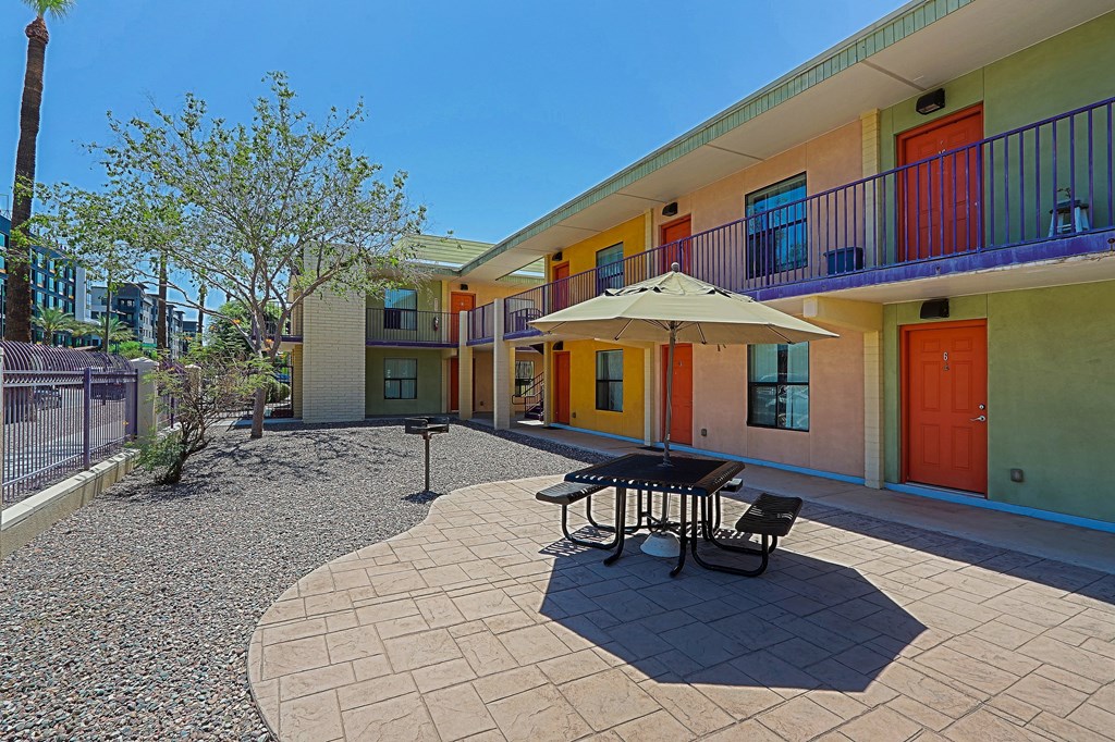 A sunny day at the colorful courtyard with a table and chairs.