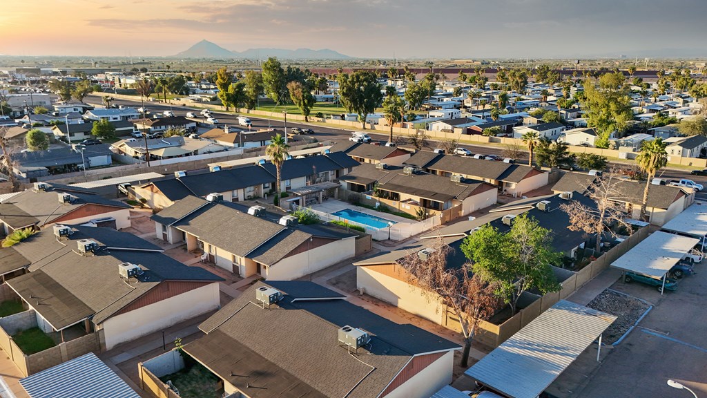 A residential area with houses and a mountain in the background.