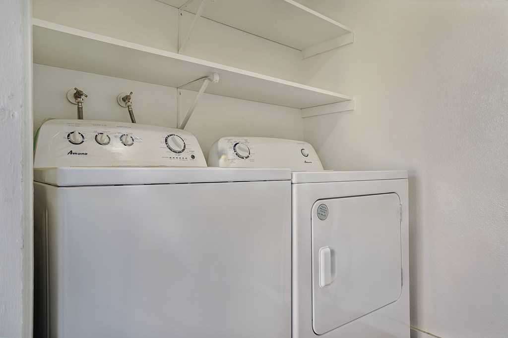 A white washing machine with the door open.