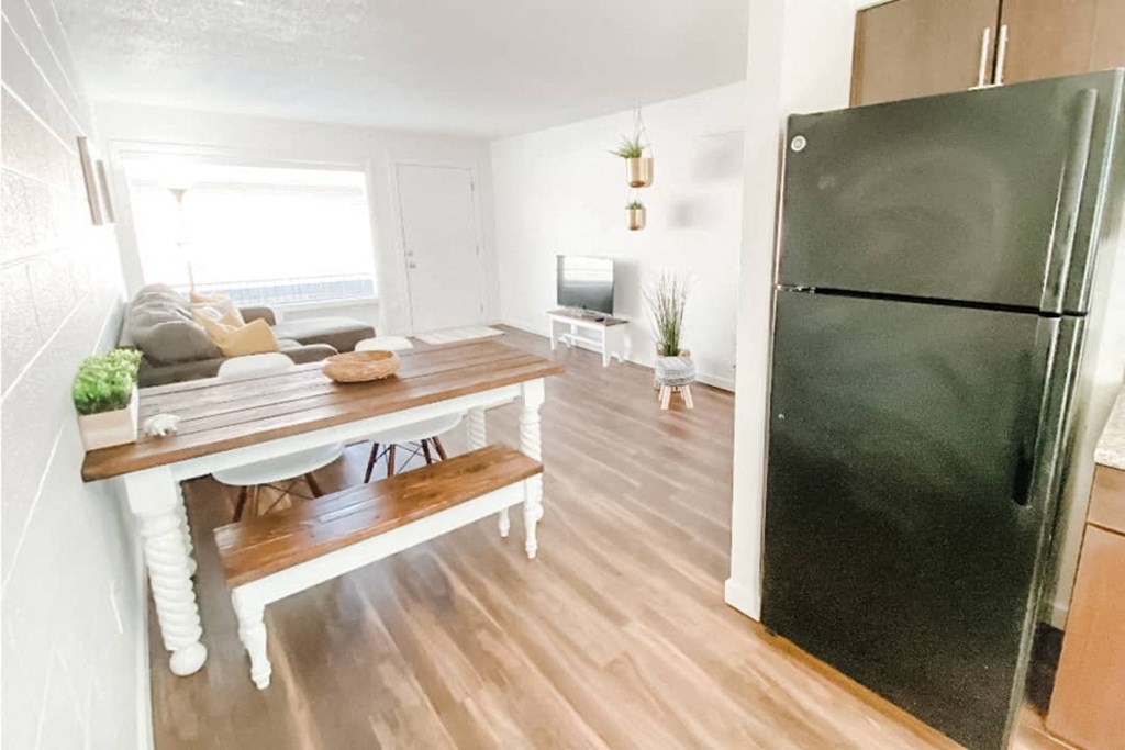 a kitchen with a table and a refrigerator
