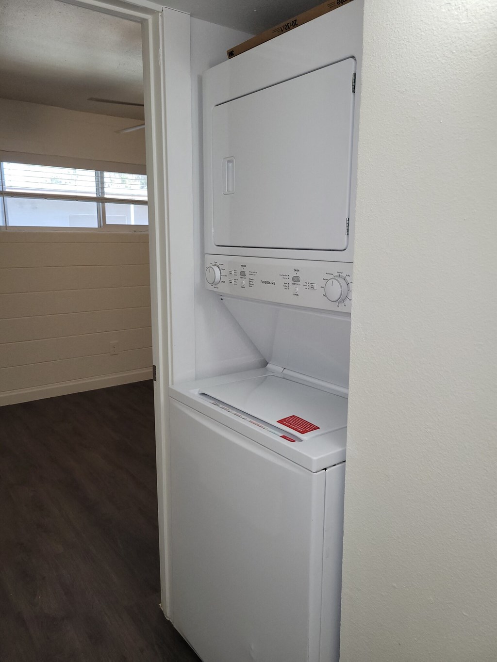 a white washer and dryer in a room with a window
