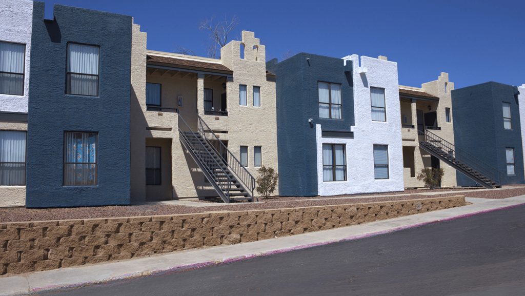 a row of apartment buildings on a street