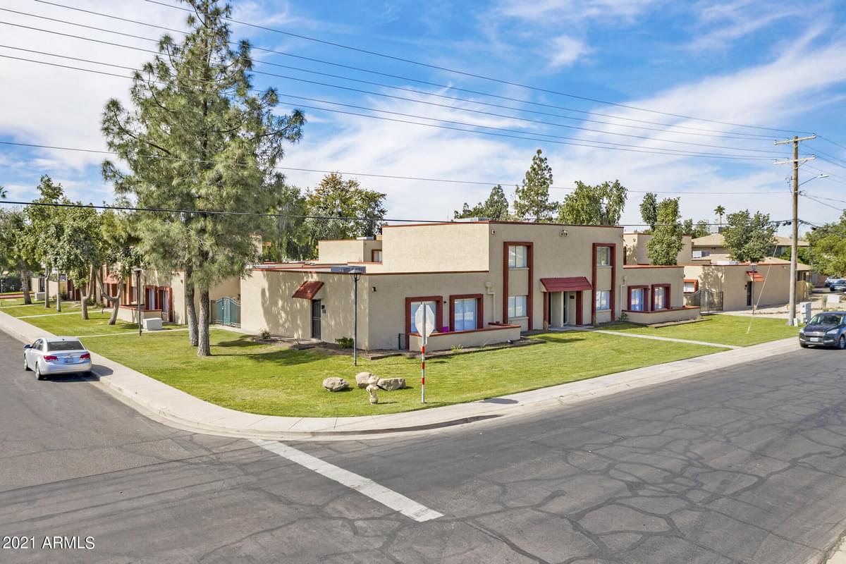 a city street with a row of houses on the side of the road
