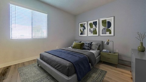 A bedroom with a bed, nightstand, and a window with blinds.