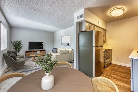A living room with a grey couch and a wooden coffee table.