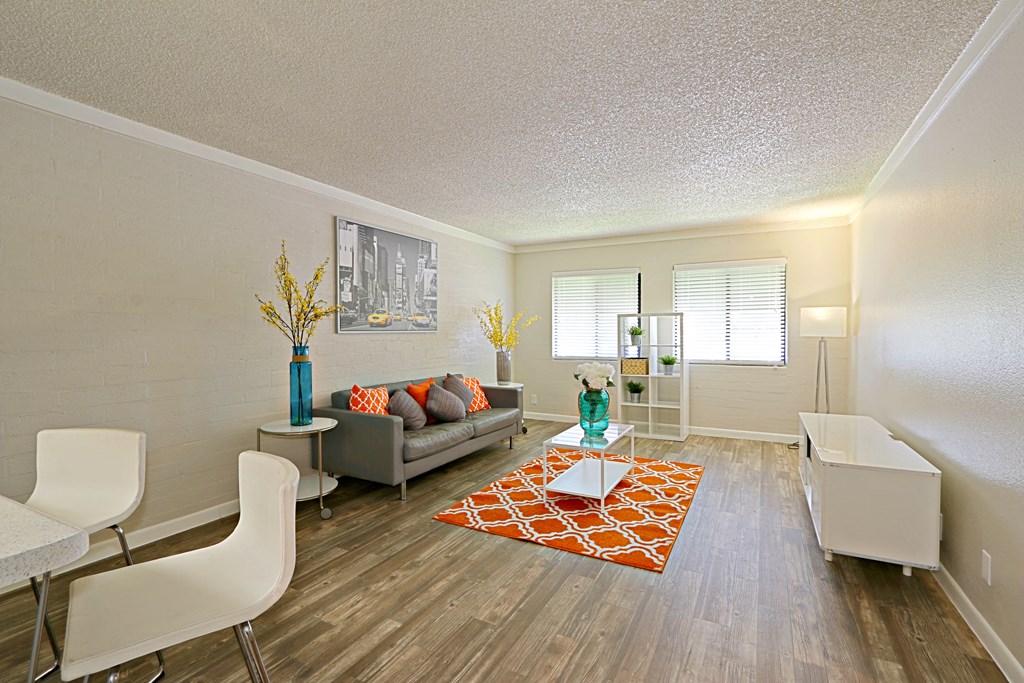a living room with hardwood flooring and white walls