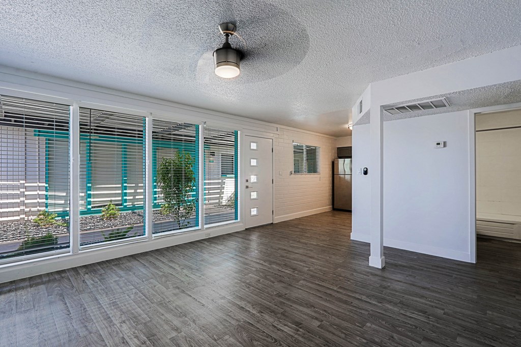 A room with a ceiling light and a window with blinds.