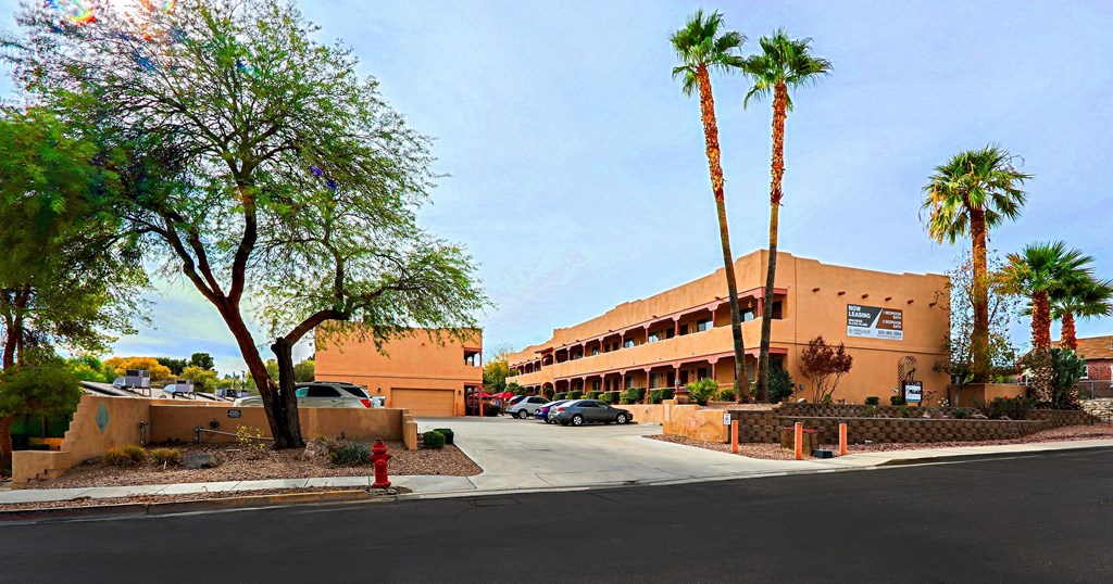 A building with a red fire hydrant in front of it.