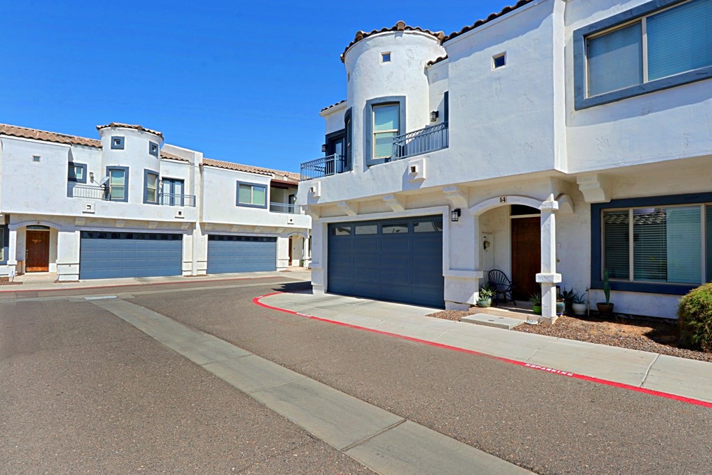 A row of houses with a red line painted on the street.