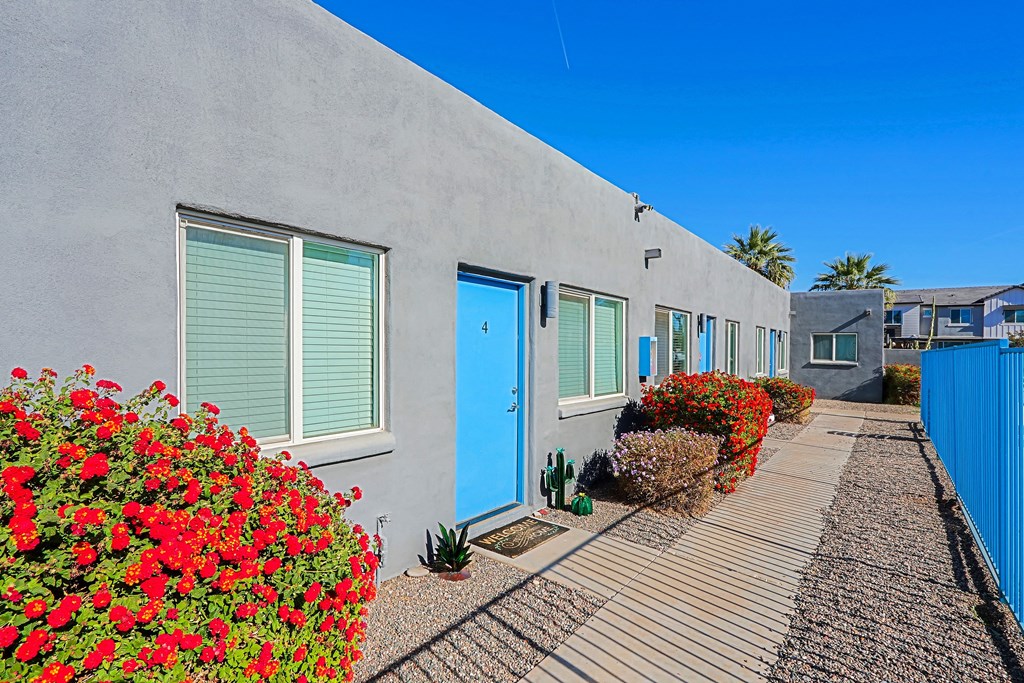 A row of houses with blue doors and windows.