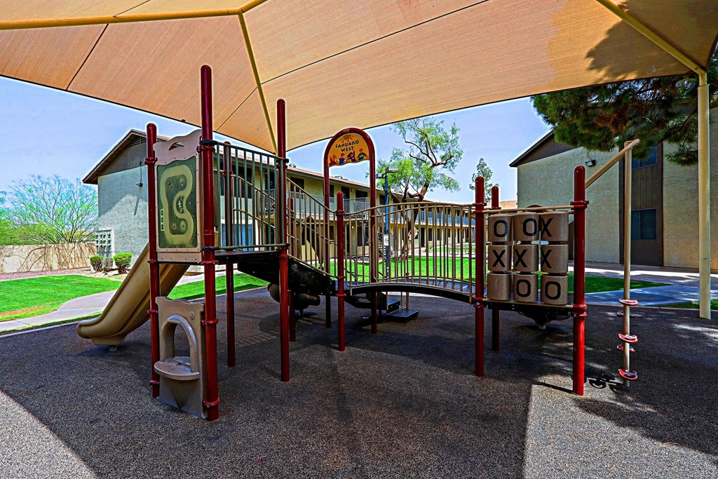 A playground with a slide and a climbing frame.
