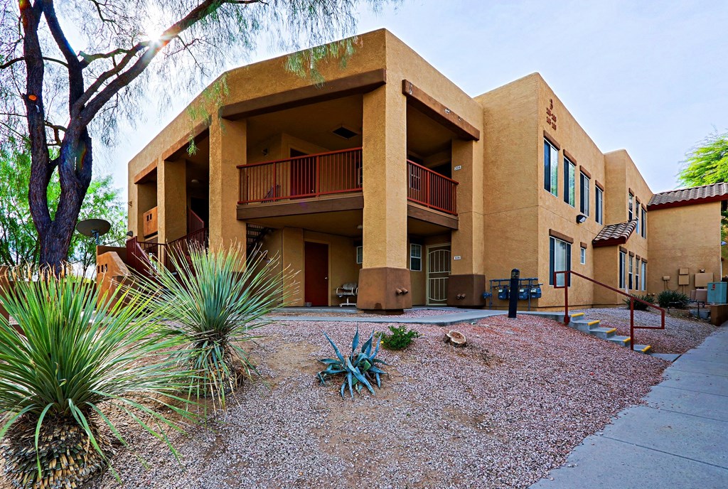 A building with a red railing on the balconies.