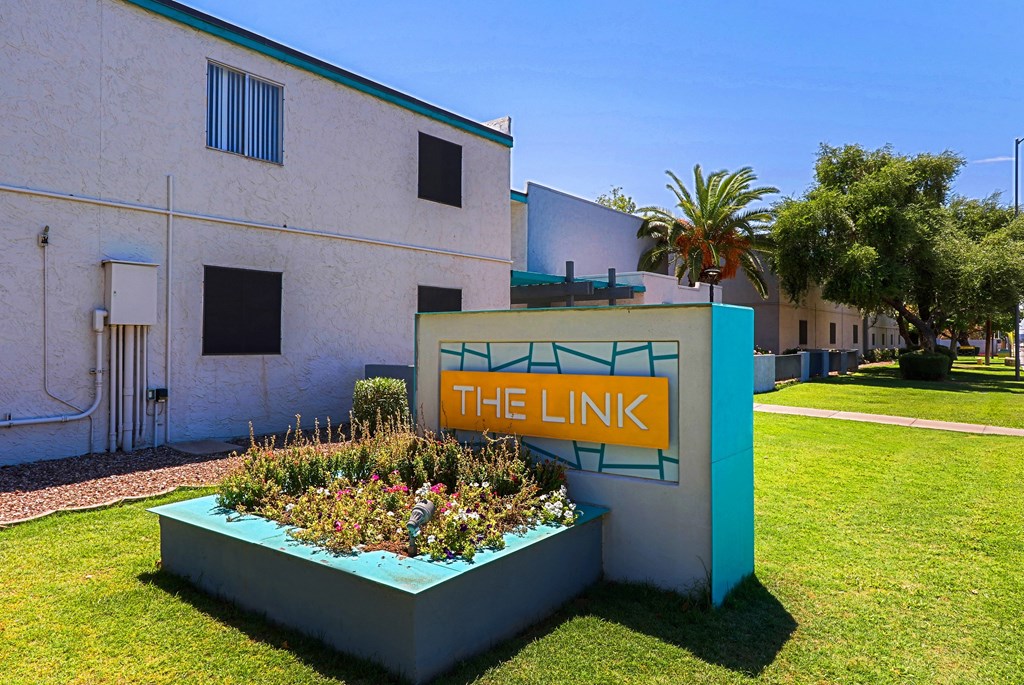 A white building with a sign that says "THE LINK".
