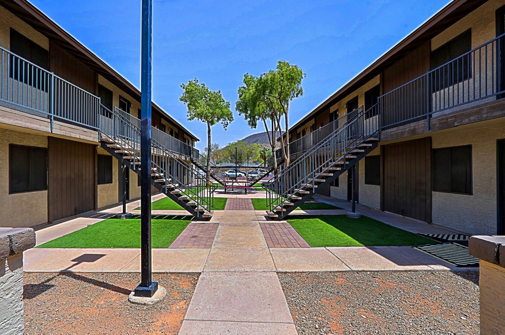 A long walkway with a metal railing on both sides.