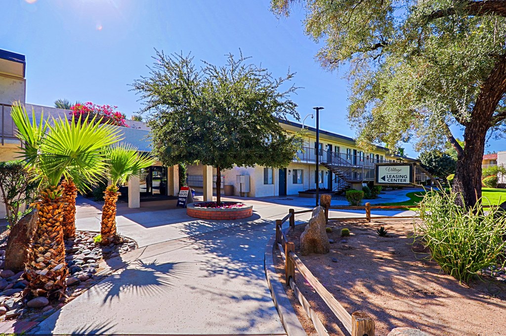 A sunny day at the entrance of a building with a sign that reads "4 SUITE".