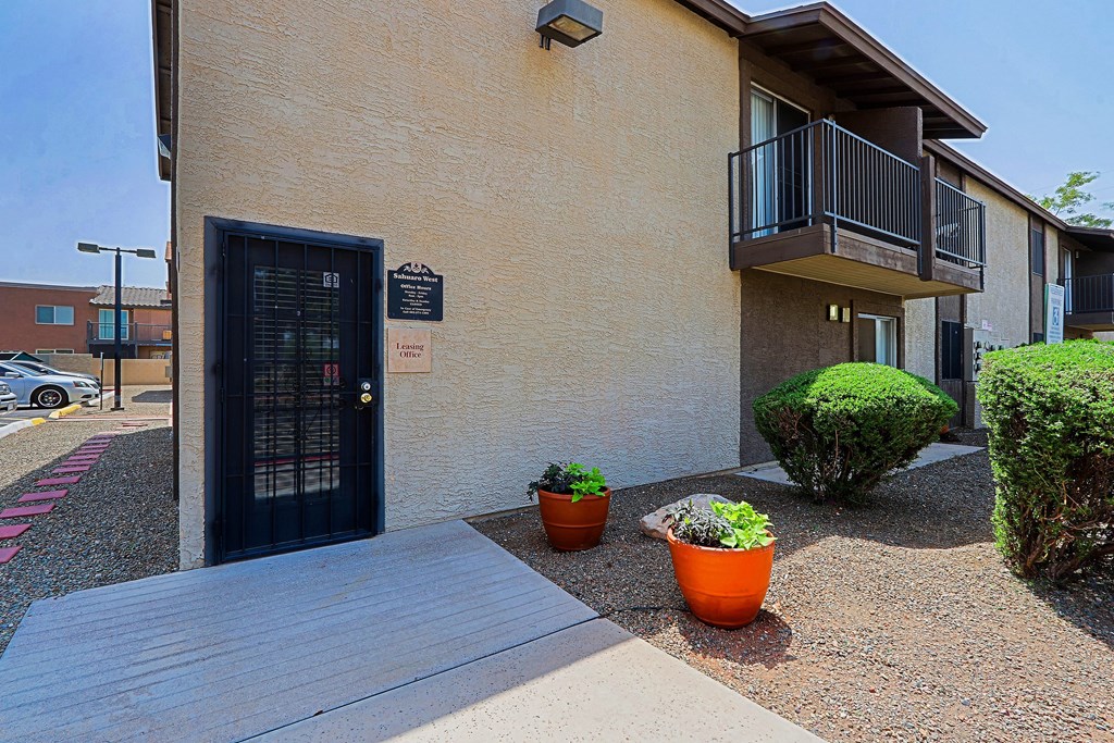 A building with a black door and a sign on it.
