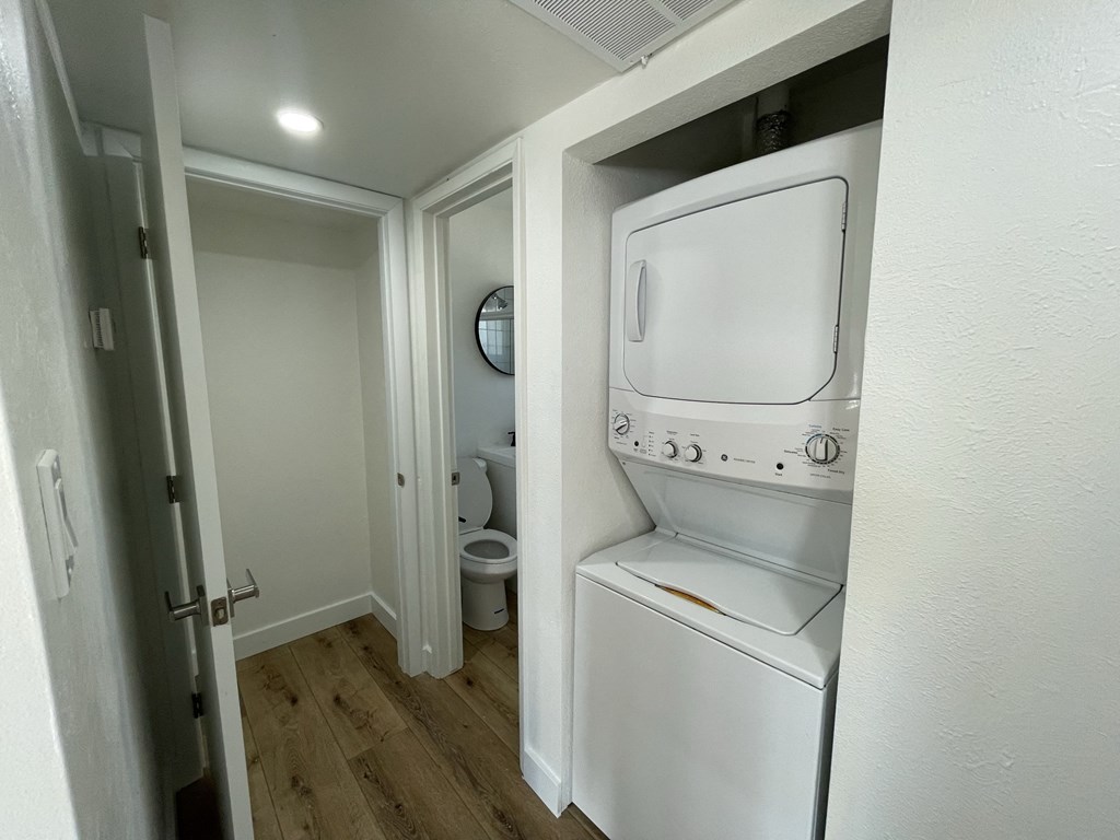 a small bathroom with a washer and dryer in a closet
