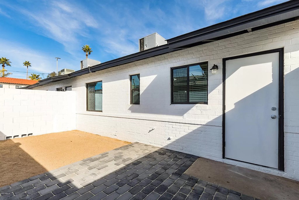 a white brick house with a white garage door