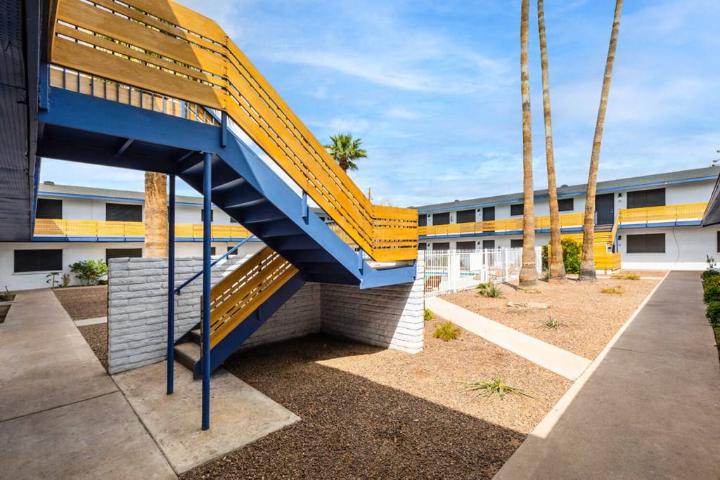A blue and yellow staircase leads up to a building.