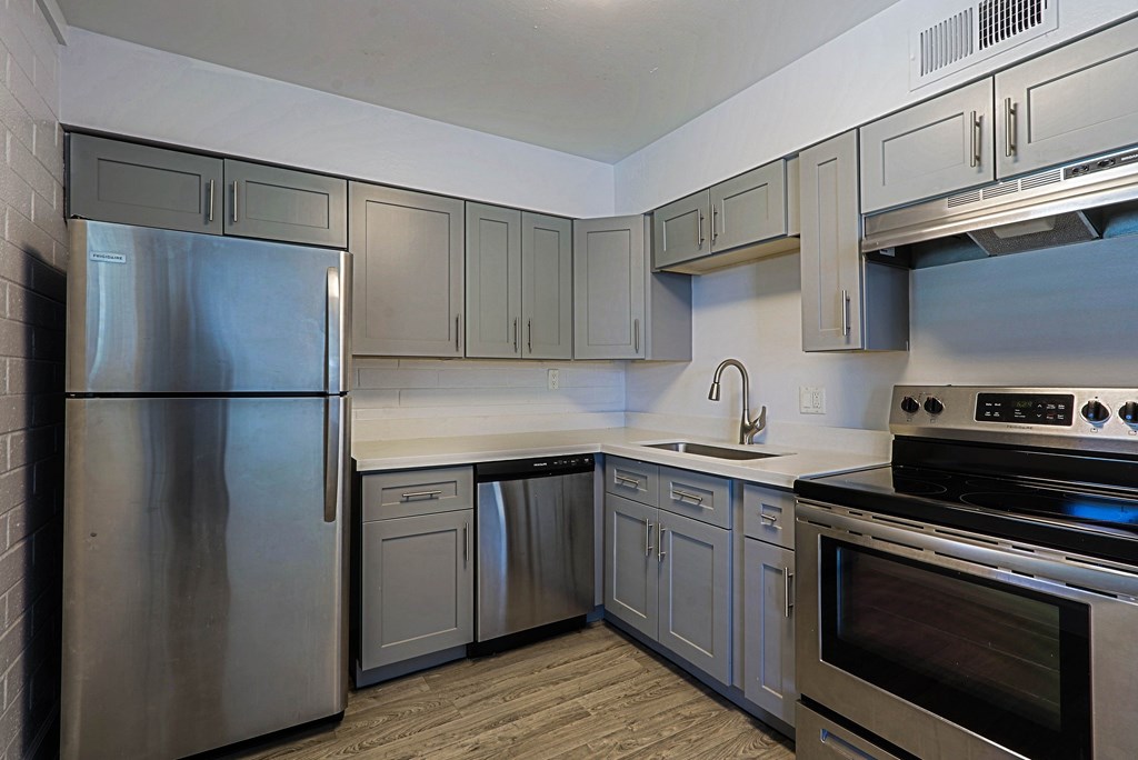 A kitchen with a stainless steel refrigerator and oven.
