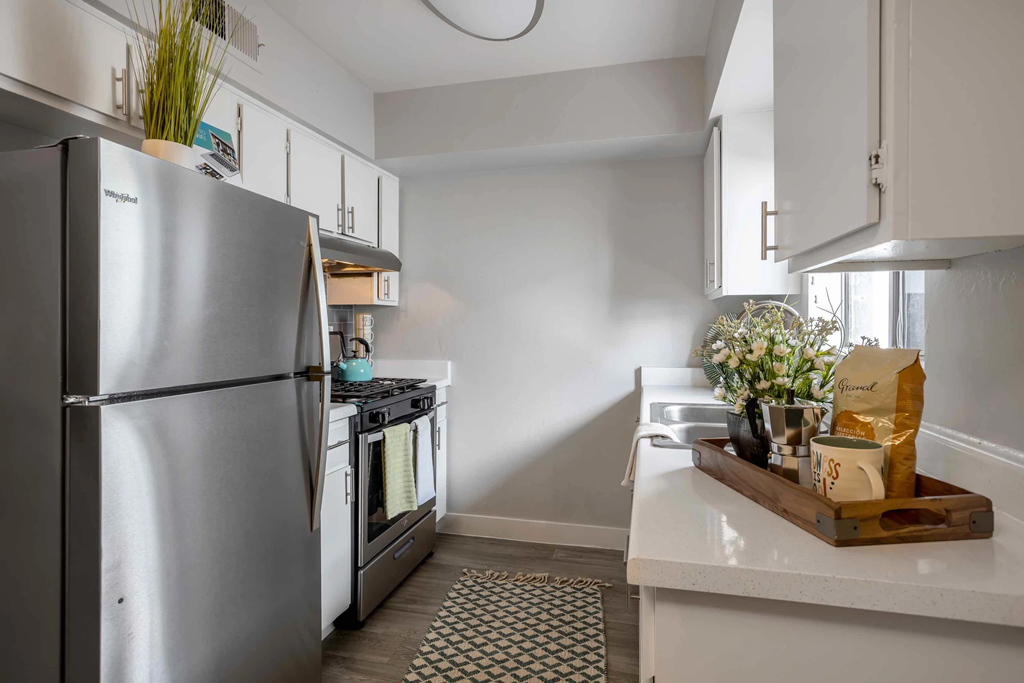 a kitchen with stainless steel appliances and white cabinets