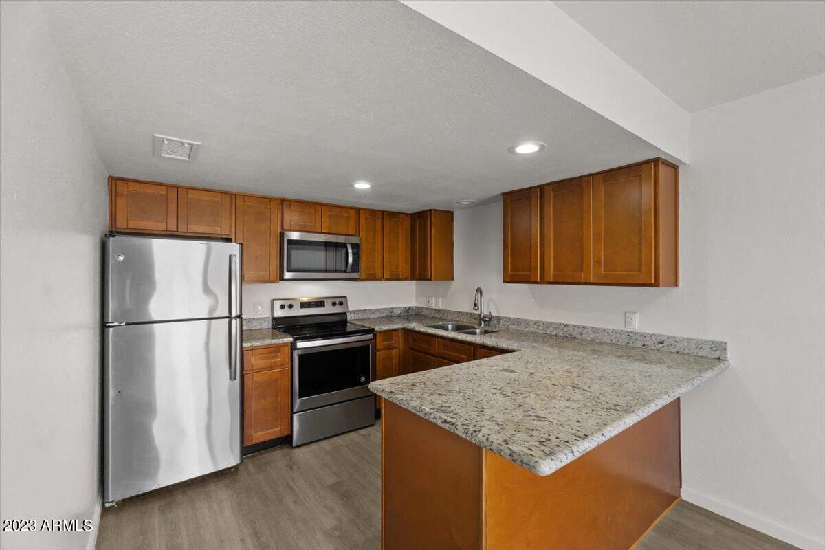 a kitchen with stainless steel appliances and granite counter tops