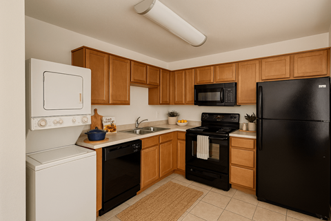 A kitchen with black appliances and wooden cabinets.