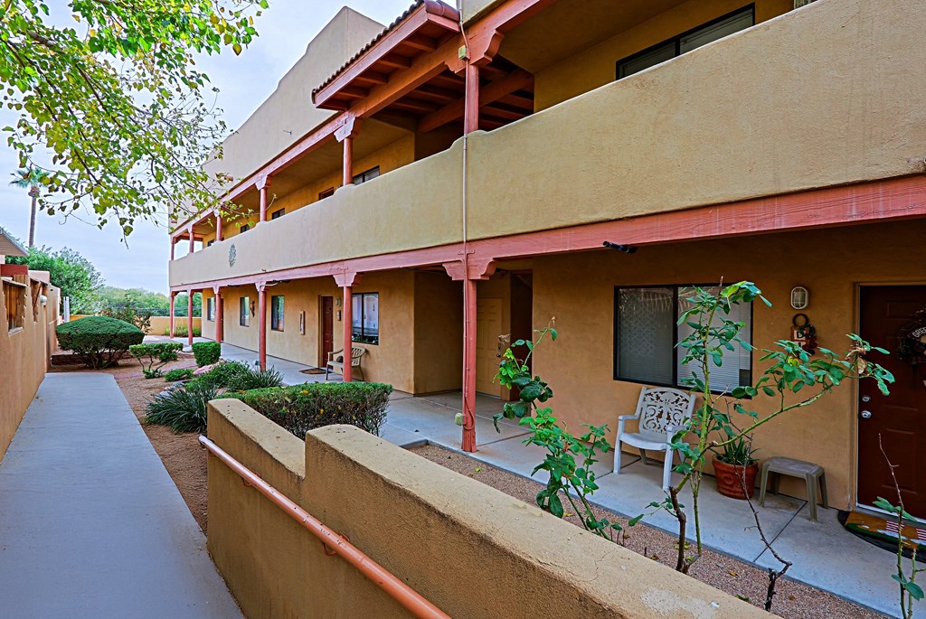 A building with a balcony and a chair on it.
