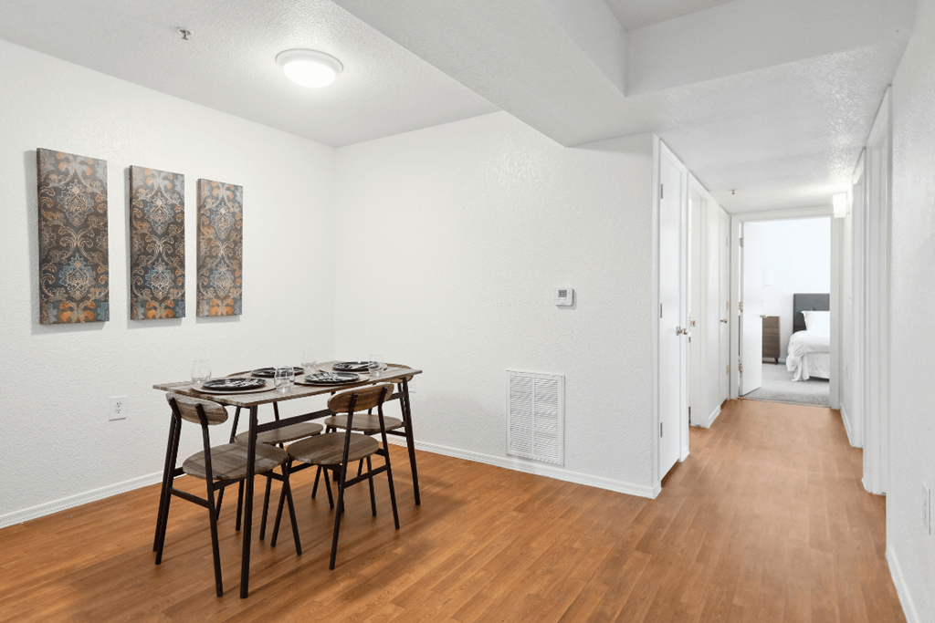 a dining room with a table and chairs