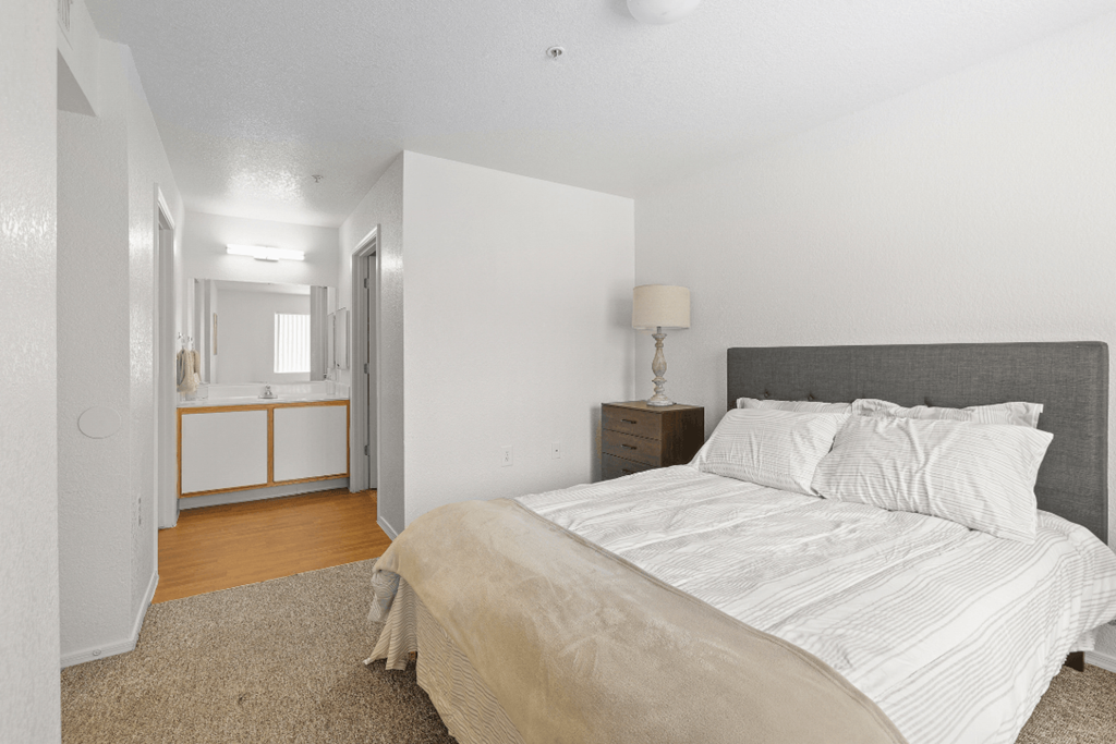 a bedroom with a bed and a nightstand