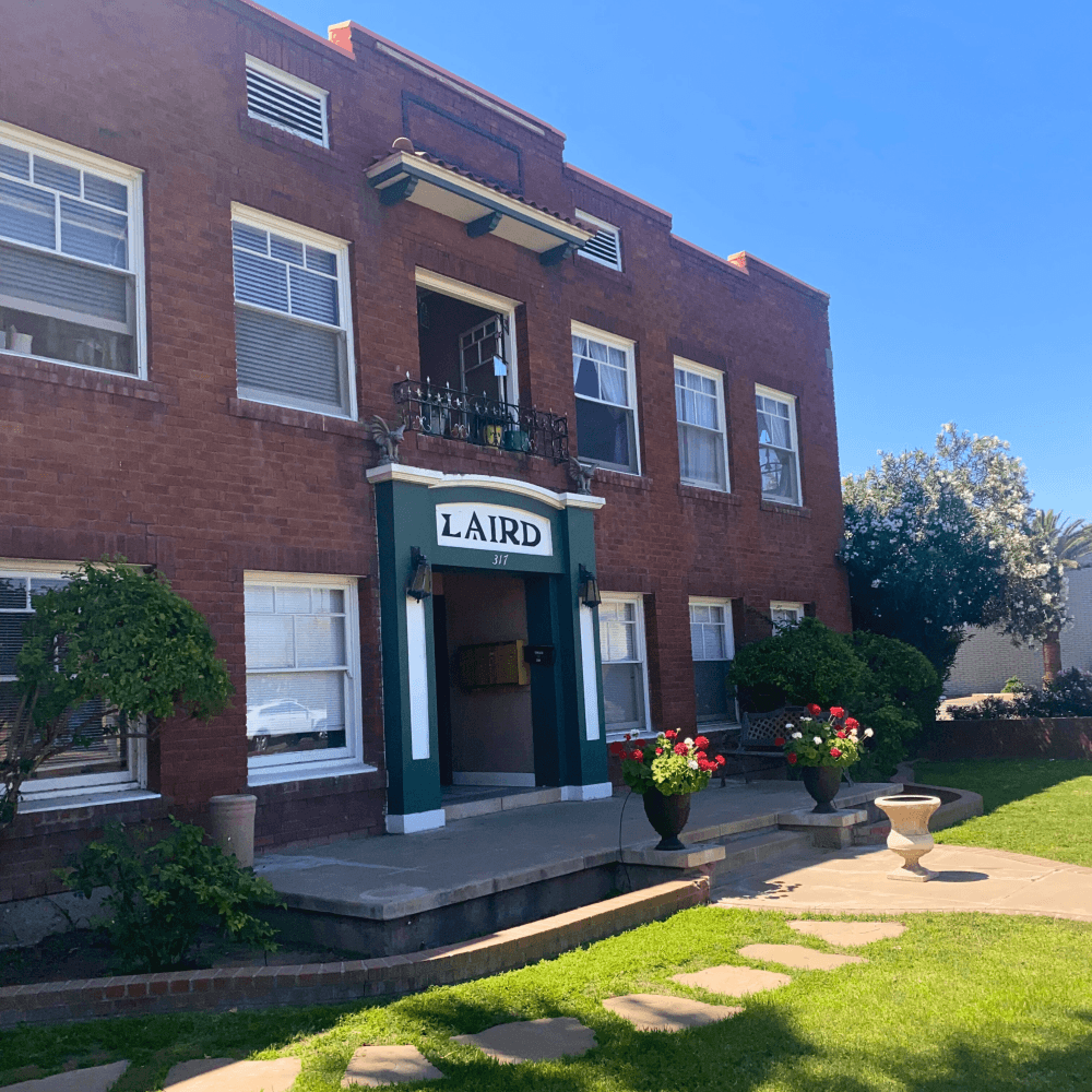 a red brick building with a sign that reads laird