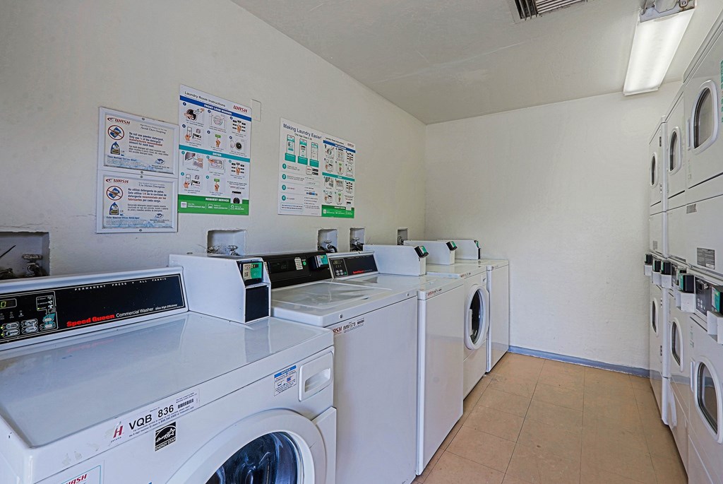 A row of washing machines in a laundromat.
