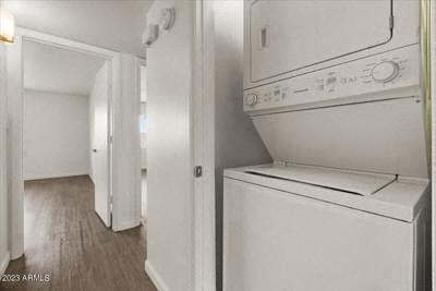 a white kitchen with a washer and dryer in it