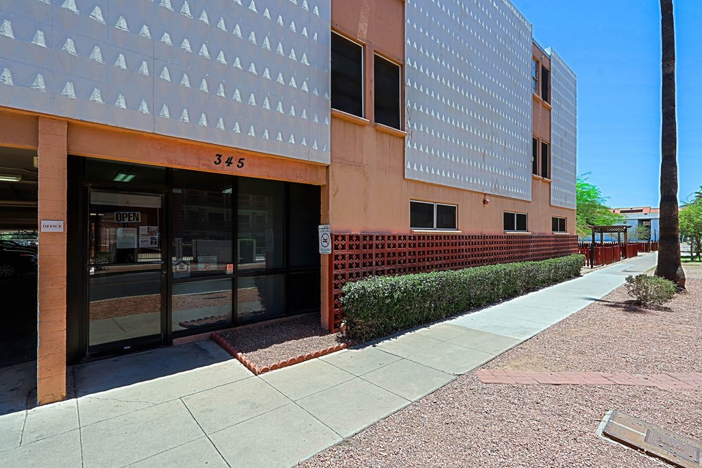 A building with a white facade has a number 345 on it.