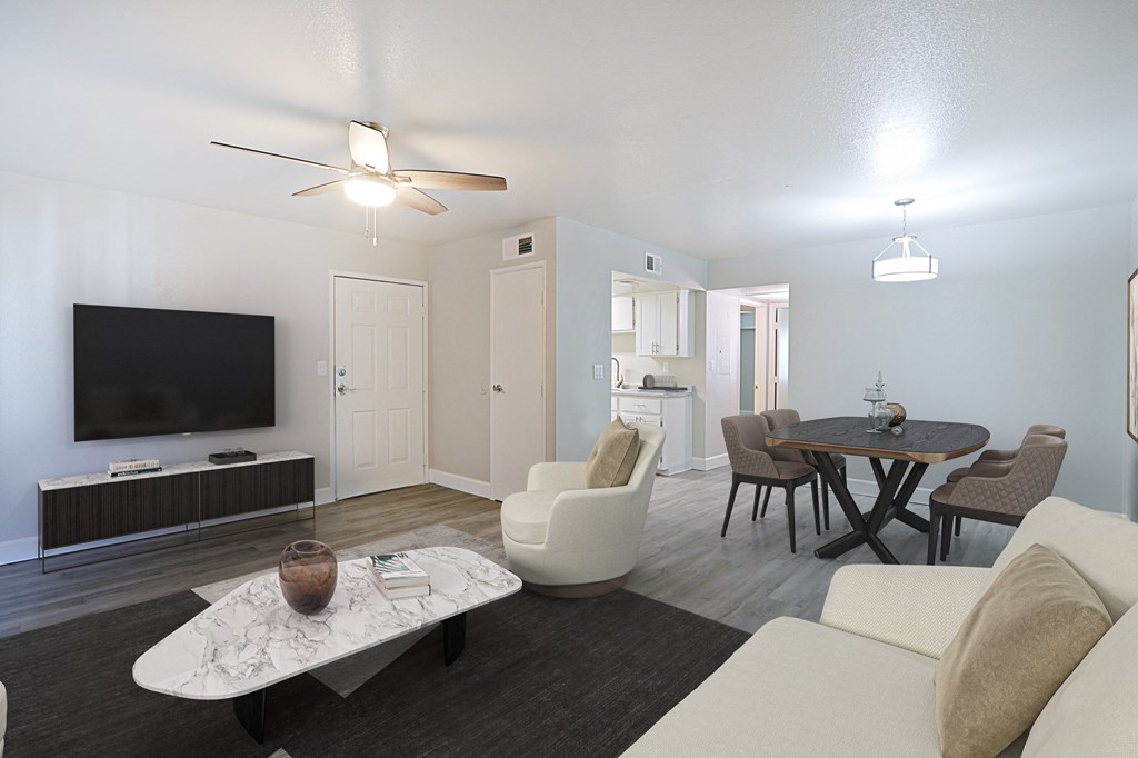 a living room and dining room with a tv and a table