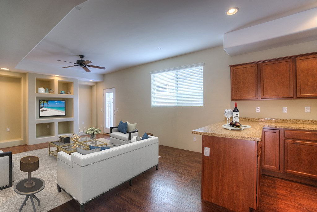 a living room and kitchen with a couch and a tv