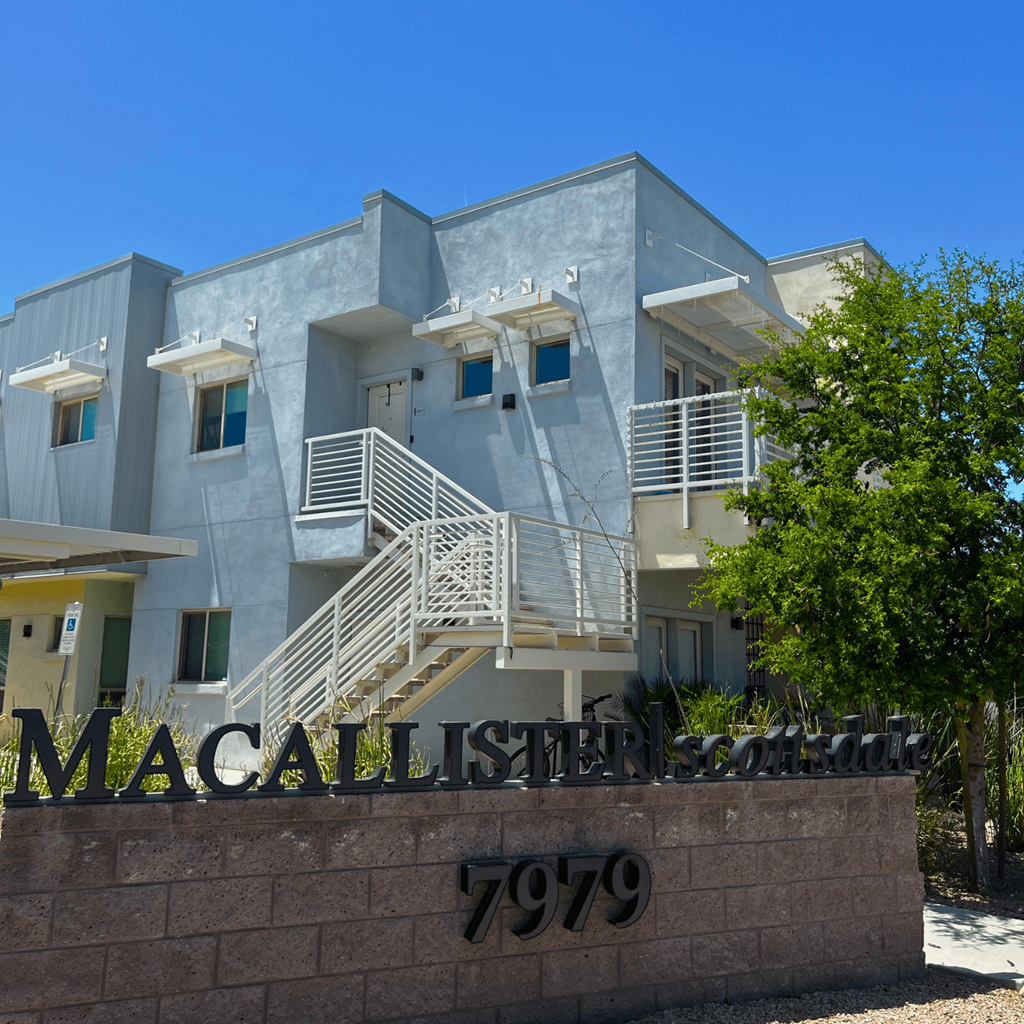 the front of a building with the mcalister street sign in front of it