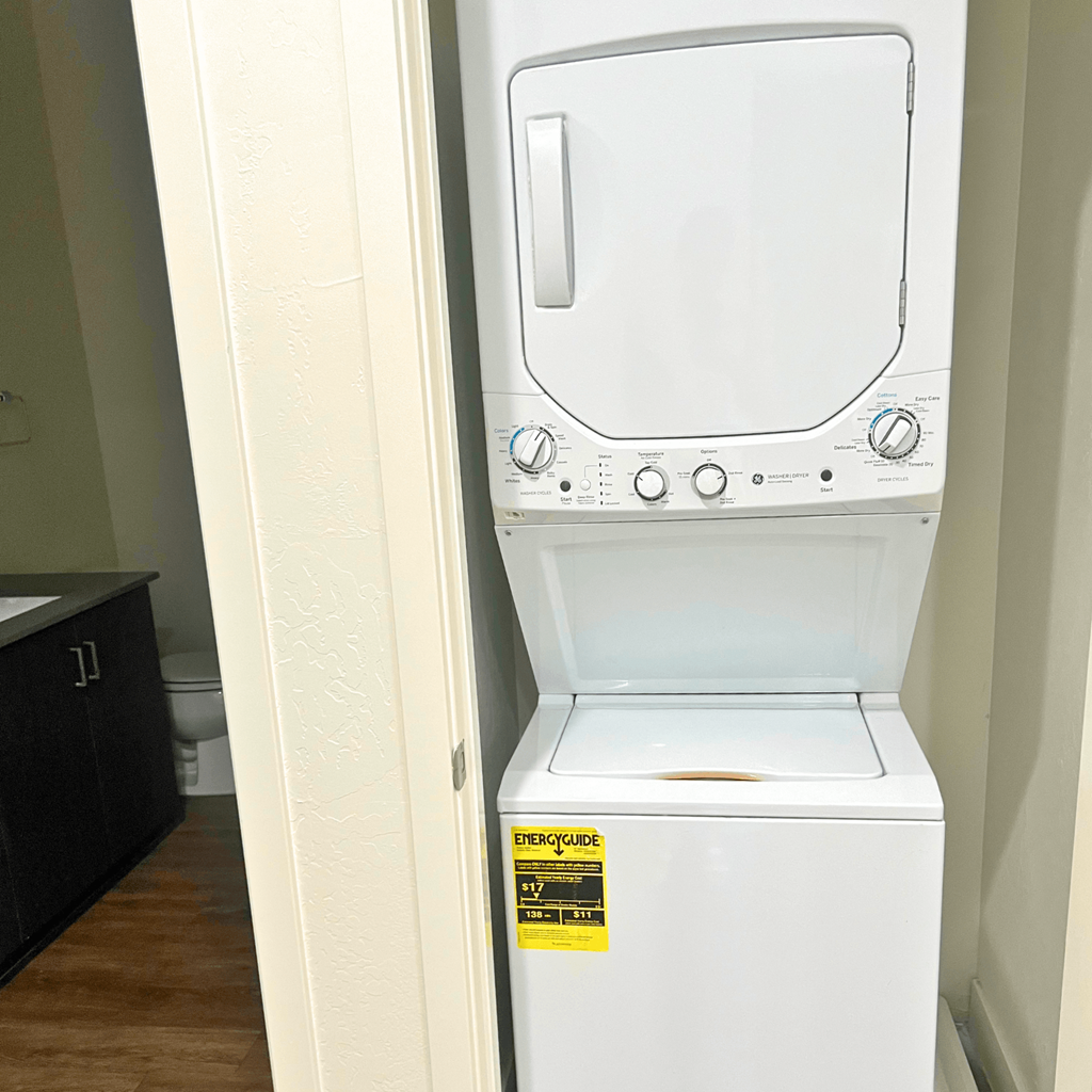 a white washer and dryer in a room with a door