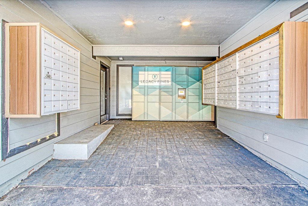a long hallway with many closets and a glass door