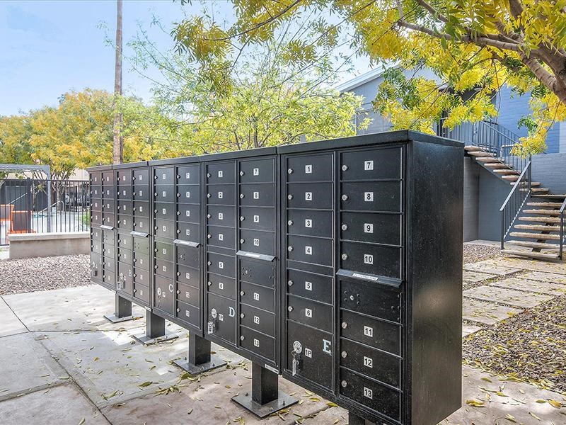 a group of mailboxes sitting on a sidewalk