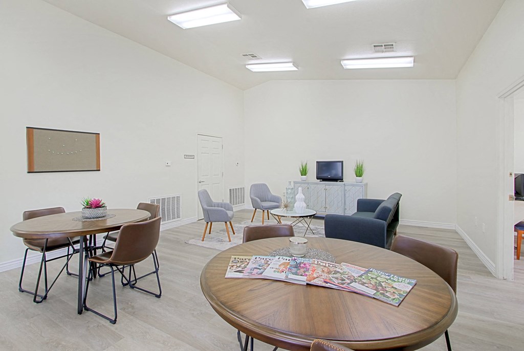 a living room with a table and chairs and a television