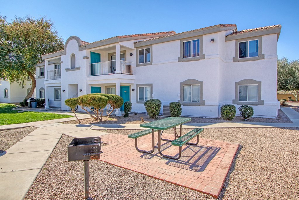a picnic table in a courtyard in front of a house