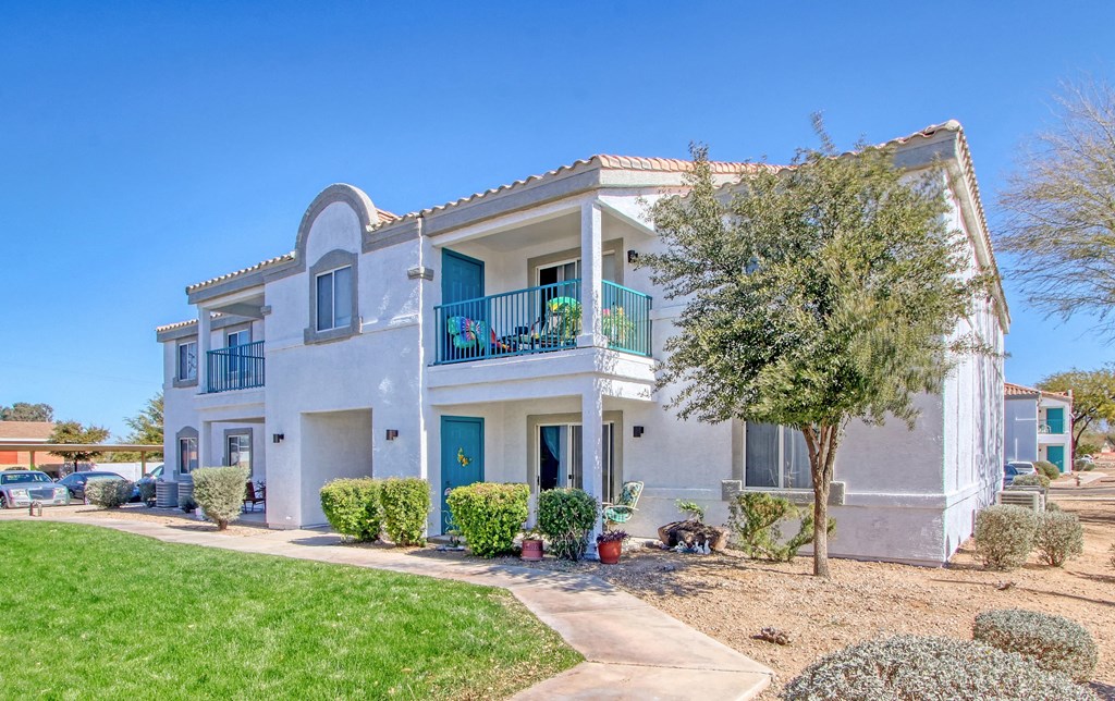 a house with a yard and a tree in front of it